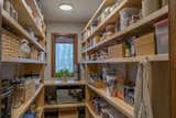 A new JELD-WEN window illuminates custom fir shelving in this pantry, with storage and functionality being the driving force of the design from Sophie Piesse.