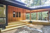 Wraparound covered porch with tongue and groove pine ceiling and cedar beam wrap and trim.