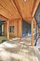 Custom cumaru inlay at the meeting point of 3 walking paths. Tongue and groove pine ceiling with cedar beam wrap and cedar siding.