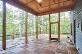 Screen porch with 13 ft ceilings leads out to rooftop deck and wraparound porch.