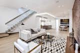 Soaring ceilings and wide plank floors in the open living room/kitchen space. 