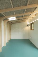 The wall features a bespoke shelving system and peg walls