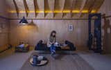 Living Room, Wall Lighting, Light Hardwood Floor, Ceiling Lighting, Sofa, Chair, Coffee Tables, and Table Lighting A place to display and enjoy art  Photo 10 of 15 in The Barn by Boano Prišmontas