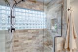 The master bathroom features a walk-in shower with rainfall shower head.