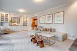 Living room with wood-burning fireplace has a low profile sofa from Article.