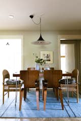 A Gubi light hangs over the custom dining table