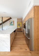 Kitchen, Refrigerator, Wood Cabinet, Marble Counter, Recessed Lighting, and Light Hardwood Floor  Photo 3 of 6 in McLendon Avenue Home by Atlanta Design Festival