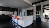 The majority of the kitchen is black and white but bright pops of color keep it modern and fresh.