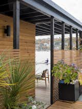 Exterior, Small Home Building Type, Flat RoofLine, House Building Type, and Wood Siding Material Deck with cedar slat screen for privacy  Photos from Lake Union Floating Home