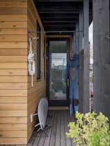 Exterior, Wood Siding Material, Boathouse Building Type, Flat RoofLine, Small Home Building Type, and House Building Type Wrap around ipe deck with doors to every room and storage  Photo 17 of 20 in Lake Union Floating Home by Atelier Drome