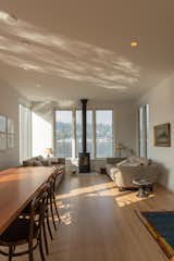 Living Room, Sofa, Recessed Lighting, End Tables, Gas Burning Fireplace, Light Hardwood Floor, and Ceiling Lighting Looking towards the living and dining area  Photo 13 of 20 in Lake Union Floating Home by Atelier Drome