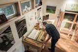 The two story working studio also acts as a work space filled with tools necessary for artists and french doors that open up to a deck to let in the sunshine and for good airflow while working.
