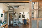 The two story working studio also acts as a work space filled with tools necessary for artists and french doors that open up to a deck to let in the sunshine and for good airflow while working.