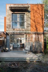 The two-story artist's studio sits on a small footprint in a residential neighborhood connecting seamlessly with the home.