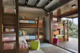 Garage-style doors open and connect the children's rooms to the outdoors.