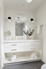 Guest bathroom features white built-in cabinetry