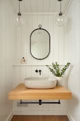 Wood paneling in the powder room is a traditional element but with a very contemporary finish.