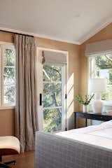 Master bedroom walls are covered with grass cloth wallpaper.