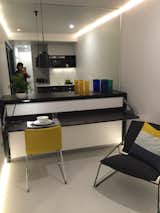 The desk and folded away bed, with full wall mirror above for that illusion of size!