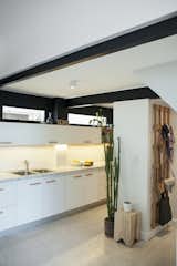 The original beams and the wall above the cupboard have been painted in black