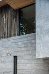 Custom ashlar granite stone from local quarry, hand-troweled natural stucco, weathered oak siding from locally storm-felled trees