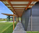 Exterior, House Building Type, Metal Roof Material, Flat RoofLine, and Shed RoofLine Covered Entry Walk  Photo 5 of 12 in Hawaii Camp Ahiki Residence by Studio Zerbey Architecture + Interiors