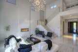 Living room/great room with gas fireplace and soaring ceilings