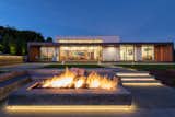 Fire Pit | View from the sunken fire pit with the outdoor kitchen, dog run and home in the background