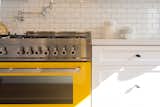 Love that bright yellow enamel stove, with stock pot water faucet