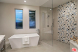 Textured mosaic tiles in shower.