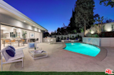 Waterfall, curved pool, and beautiful landscaping.