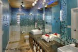 Bath Room, Vessel Sink, Granite Counter, Open Shower, Pendant Lighting, One Piece Toilet, Accent Lighting, Wall Lighting, and Glass Tile Wall  Photo 1 of 2 in Caribbean Beach Gradient Glass Tile Bathroom Design by Susan Jablon