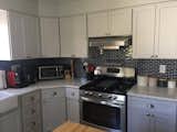 This remodeled kitchen features our 1x3" Navy Blue Glass Subway Tile (Sku# 5371610). Customer Adele M. says "We love the tiles and how the light reflects and shines off them. Makes the space so much more bright." Did you know that we have this 1/3" Subway Glass tile in 55+ colors? http://ow.ly/EGN930hOvcc #tile #mosaictile #glasstile #kitchenremodel #homedesign #kitchendesign #interiordesign #modernkitchen #backsplash #homedecor #homeimprovement