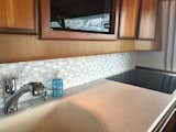 Susan Jablon White Mother of Pearl & Stone Glass Tile blend consists of Mother Of Pearl, Sandstone Beige & Textured Light Gray Glass Tiles. This customer installed it in the galley of her boat for beautiful results!
#tile #cottagestyle #beachhouse #vacationhome #glamour #tilestyle #outdoorliving #smallspacesquad #boattour #sodomino #interiorlovers