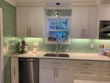 Mint Green tile is captivating when paired with white cabinets and stainless steel applicances