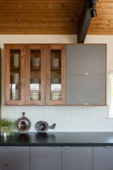 Grey laminate cabinetry is juxtaposed with claro walnut, which has a sculptural look.