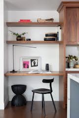 A desk area with open shelving further maximizes space and can accommodate a roll-up chair if needed.