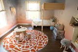 The walls are covered in Calico’s ombre wallpaper and create the room’s backdrop, a song to the African sky at dawn. For an unexpected layer, artist Cody Blocker painted silhouettes of safari animals. 