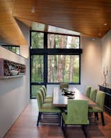 The dining room was envisioned as an “eddy” in the circulation path. Folded planes of the ceiling intersect above the dining room, the corner lifts to allow more light and view of the cottonwoods by the creek.