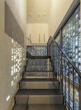 Staircase, Metal Tread, and Metal Railing The Music Box's perforated facade allows light to pass through and filter down to the lower level while maintaining privacy for those inside.  Photo 3 of 9 in Victorian Music Box by CCY Architects