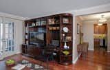 We added a new header over the space that connects the living room into the foyer in order to help define the space. We also added some crown and base moldings, and new wood floors throughout for a richer, more detailed look.
