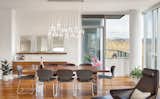 Custom, hand-blown, multi-pendant glass fixture floats above the dining table