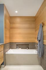 Mixed materials are presented in the tub alcove