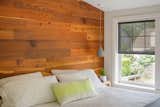 Cozy and minimalist, the wall becomes the headboard and focal point 