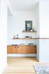 Hallway and Light Hardwood Floor Custom walnut built-ins give purpose to an extra wide hall  Photo 16 of 40 in Wister Front Room by Chelsea Ingram from Cosmopolitan  Pied-A-Terre