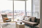 Living Room, Sofa, Chair, and Light Hardwood Floor Commanding views of Portland's bridges called for quiet and low-profile furnishings  Photo 4 of 11 in Cosmopolitan  Pied-A-Terre by Guggenheim Architecture + Design Studio