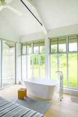 Bedroom and Light Hardwood Floor Upcountry Maui Cottage and Barn:  soaking tub in master bedroom  Photo 1 of 22 in Haiku Maui by Guggenheim Architecture + Design Studio