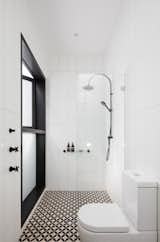 The ensuite bathroom and shower zone connects to a verdant private courtyard.