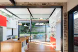 Sliding glazed panels stack back allowing the living spaces to spill out to the terraced courtyard and yard.