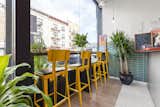 Greenery abounds throughout the cafe. This seating area faces the outside, adding to the indoor-outdoor experience. 
